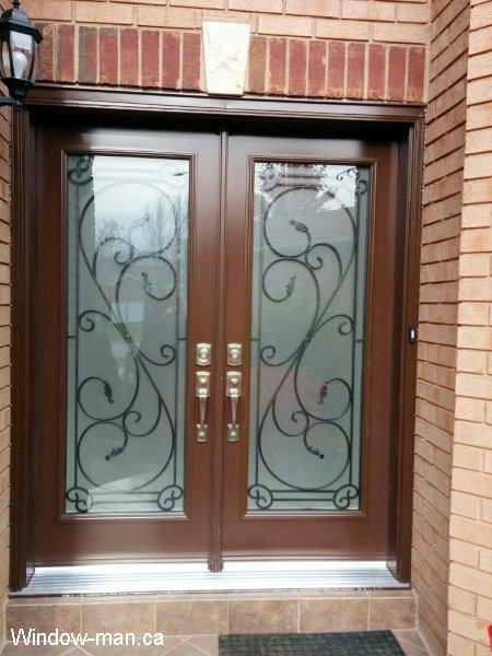 Double front entry steel insulated exterior doors. Brown spray booth paint. Flamingo bay wrought iron glass inserts